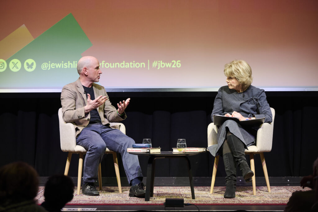 two people sitting on a chair live and talking to each other